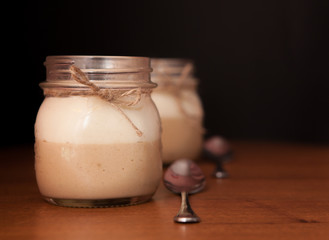 Delicious Dessert in a glass jar on a black background