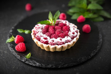 Pastry berry tart. Delicate crispy, crumbly dessert with raspberries and mint. Assorted Confectionery Range.