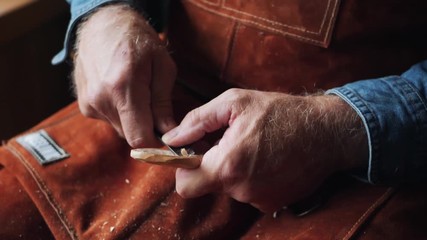 Close up of Artisan Craftsman Carving Wooden Spoon