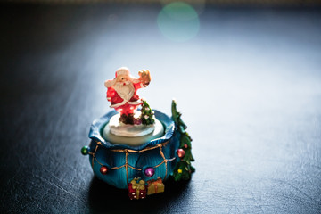 Cute toy Santa Claus on black background
