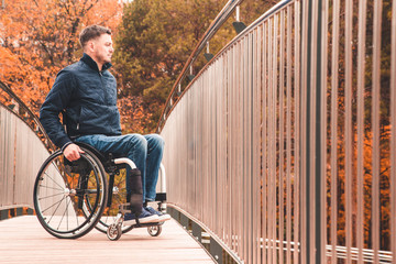 Man in a wheelchair use a wheelchair ramp.