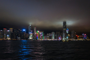 Night view of Hong Kong Central skyline with the top of skyscrapers surrounded by clouds and mist