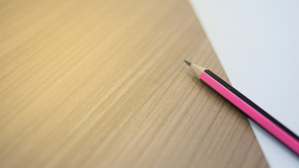Pencil and white paper on the desk, at work, in the office