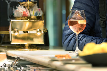 A male customer having a drink sitting in the counter - bar in Venice, Italy.