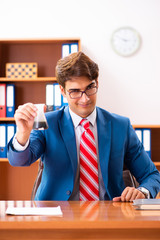 Young handsome politician sitting in office 