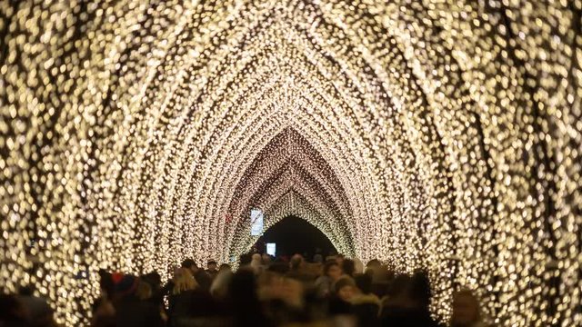 Christmas lights tunnel. Time-lapse of visitors walking under the lights and taking pictures.