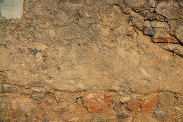 Old beige stone wall background texture close up