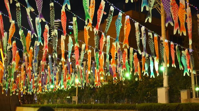 flying fish decoration, night time sightseeing under tokyo tower during a festival