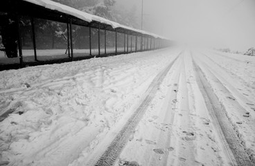 Snowy road and bus station. Foggy blank road. Izmir, Turkey.