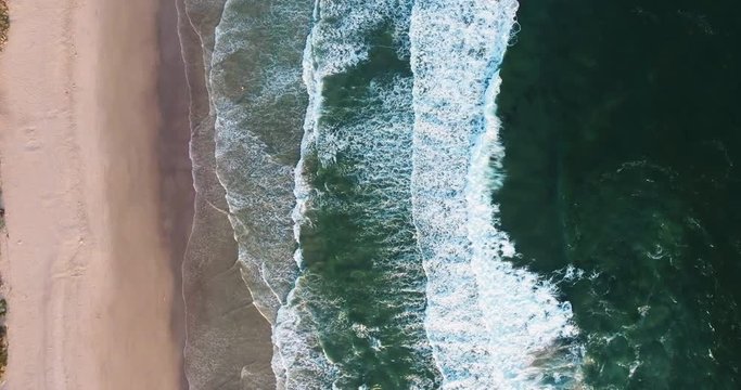 Aerial Drone Shot Top Down View of Ocean Waves Rolling onto the Beach