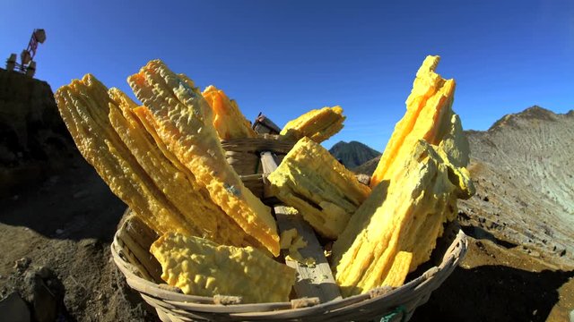 Sulphur blocks mined by local workers on mountain volcano Java 