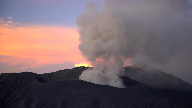 Mt Bromo at sunrise an active volcano erupting smoke and ash Java