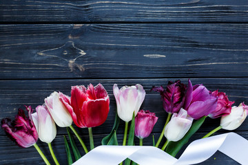 colorful beautiful pink violet tulips on gray wooden table. Valentines, spring background. floral mock up.  with copyspace. happy mothers day, romantic still life, fresh flowers