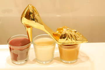 Golden heels and a glass of drink