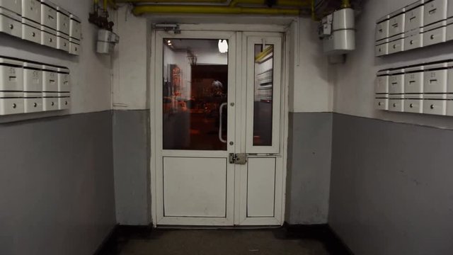 Going out to the door from old block apartments from Romania