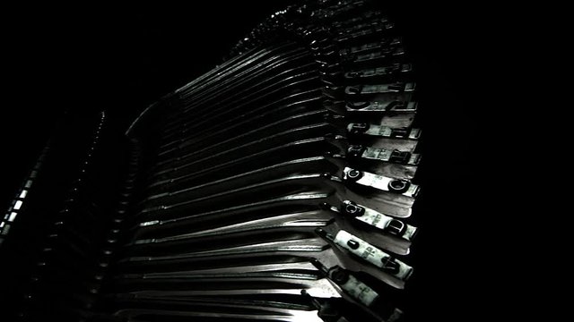 Camera panning across metal printer head of old typewriter.  Idea for opening title sequence.