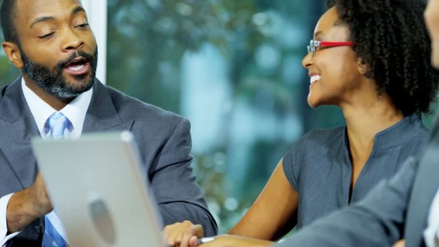Confident African American male business financial advisor in a meeting planning future projects with his colleagues 