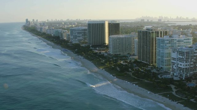 Aerial sunset view of Surfside a tropical waterfront luxury Condominium resort Bal Harbour Miami Beach Florida American 