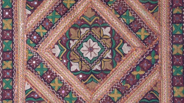 Detail old colorful patchwork carpet, establishing shot. Close up