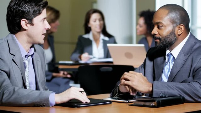 Group of multi ethnic business people using modern technology meeting in atrium modern office building 