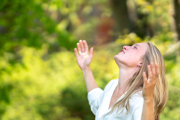 Euphoric woman laughing outdoors in nature