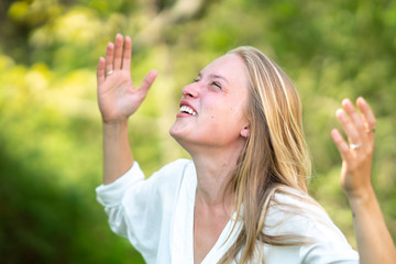 Euphoric woman laughing outdoors in nature