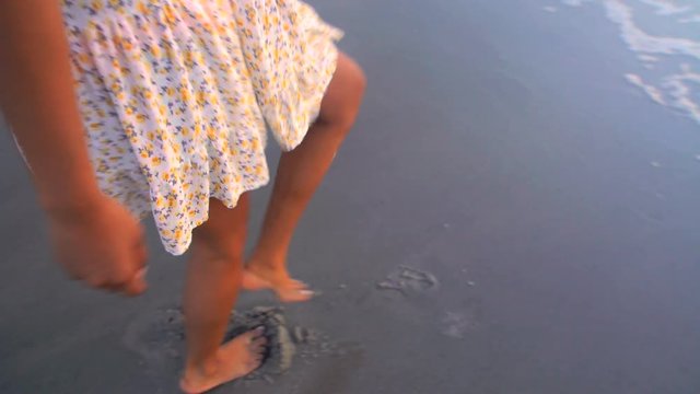 Young beautiful Indian American girl chilling and dancing barefoot on the beach at sunrise