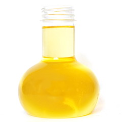 Transparent glass open flask with yellow vegetable sunflower oil on white background. Isolated