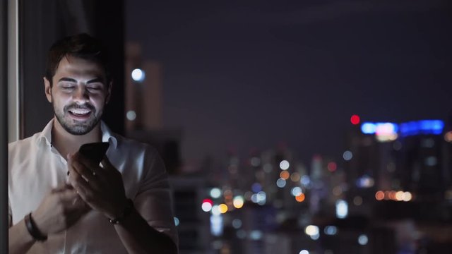 Young Handsome Man Sends Voice Message Using Smartphone