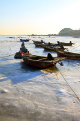 fishing boats, ice and snow by the sea