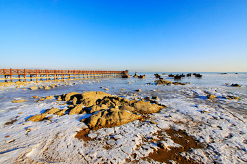 Wooden trestle in ice and snow