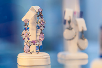 earrings and ring with precious stones. Set of earrings and a ring with precious stones in the shop.