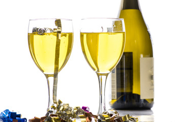 Two glasses with wine, champagne on the background of the bottle and tinsel