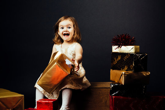 Smiling girl opening gift