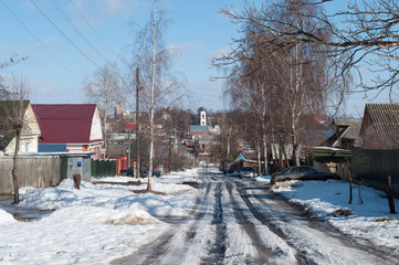 Fototapeta na wymiar Snowy street in small town, sunny day