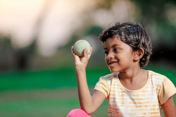 indian girl child playing with ball