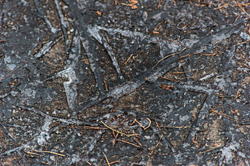 Texture of dirty ice on asphalt