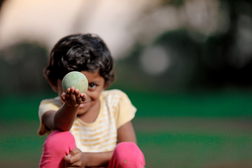 indian girl child playing with ball