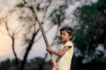 indian girl child playing cricket