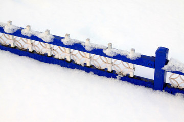 blue metal fence in the snow
