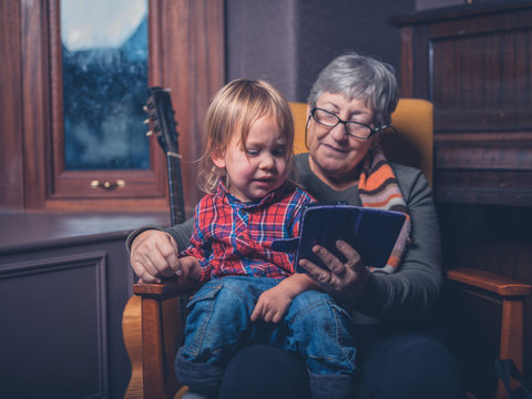 Toddler and grandmother looking at smartphone