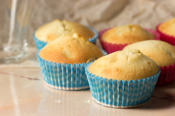 Cupcakes in colored paper forms on the table.