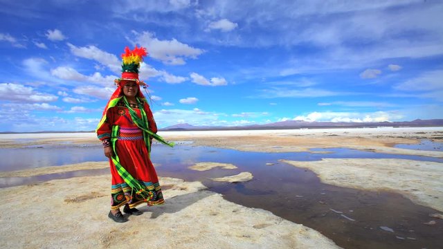 Latin American Indigenous women in traditional National Headdress and costume on Salar de Uyuni Bolivian Salt flats 