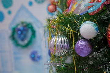 A Christmas ball hangs on the background of a clock. It's time for a new year. Multicolored glare...