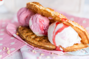 Closeup of waffle with ice-cream and syrup