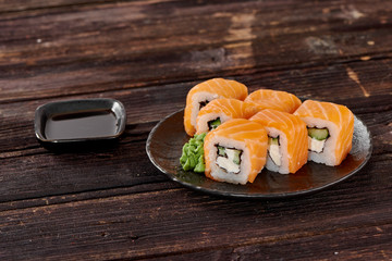Philadelphia sushi on dark wooden background