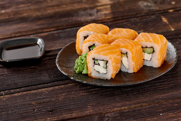 Philadelphia sushi on dark wooden background