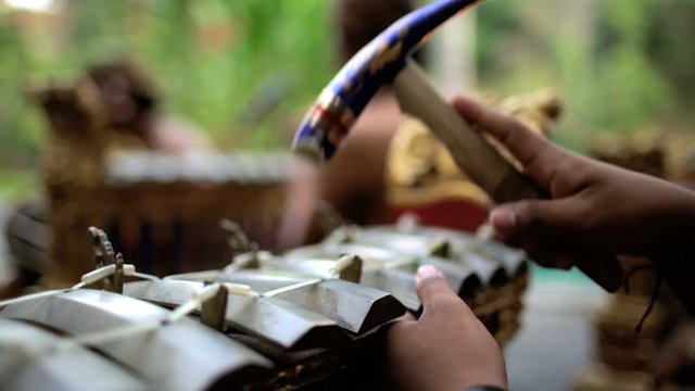 Asian Balinese musician gamelan group playing in traditional dress in a ceremonial celebration performance Indonesia South East Asia