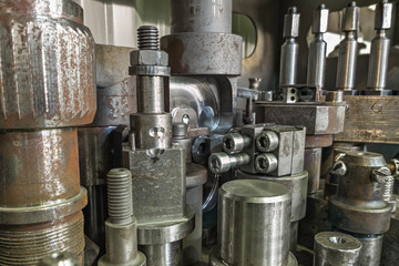 A lot of old rusted machining stock holders dark industrial back