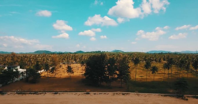 Aerial drone view of beautiful tropical island with sandy beach and green mountains. Summer and travel vacation concept